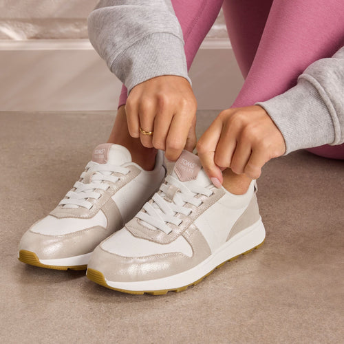 On model image of the TRVL LITE Retro Runner Sneaker in Water Repellent Champagne Shimmer