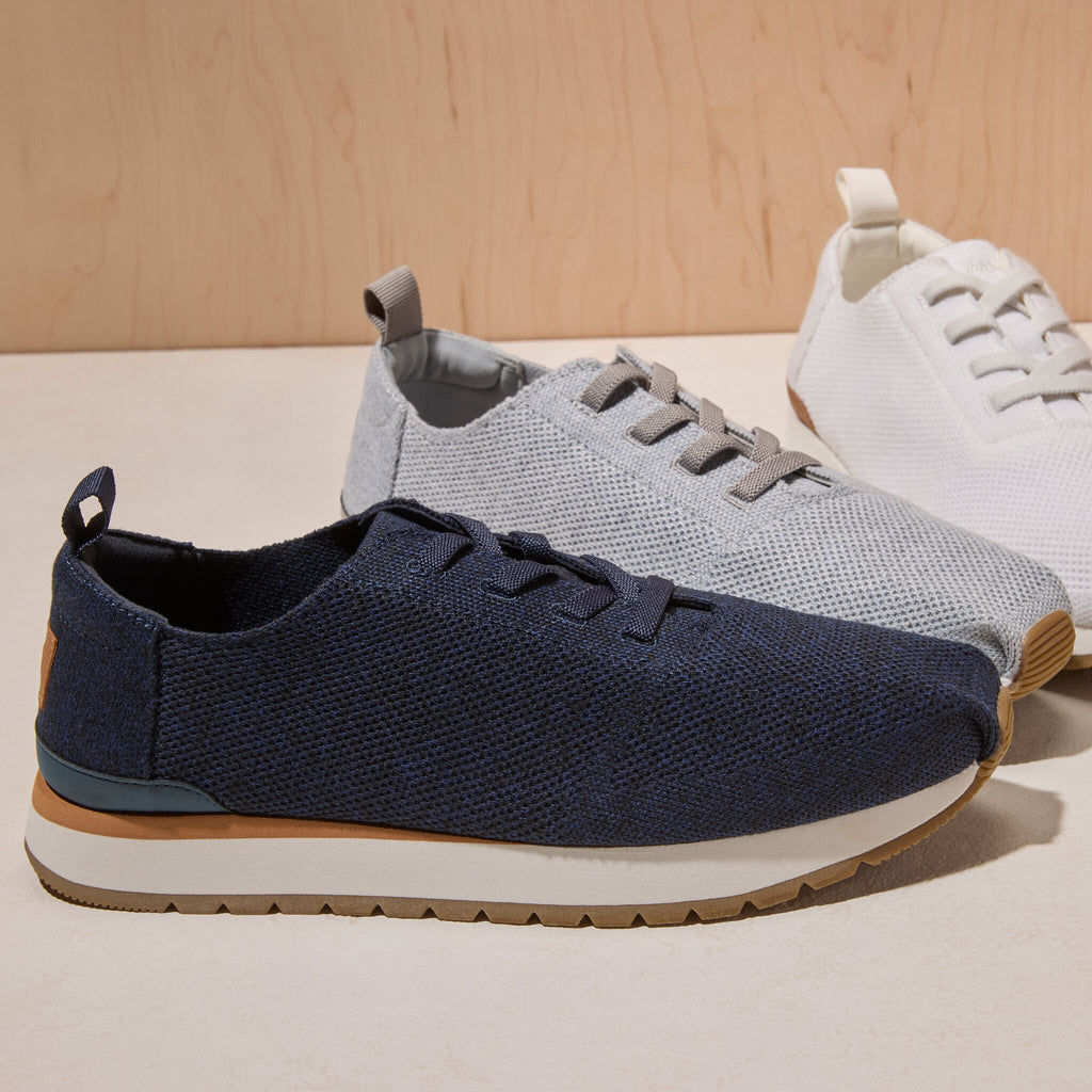 Laydown image of the navy engineered knit lace up Resident Plus