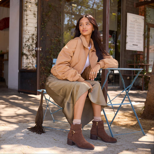 On model image of the Womens Delilah Buckle Ankle Boot Hot Cocoa Suede