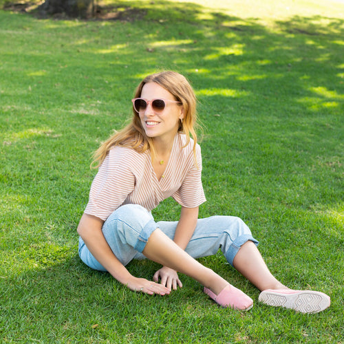 Women's Aaryn Handcrafted Sunglasses Collection in Apricot colorway on model image