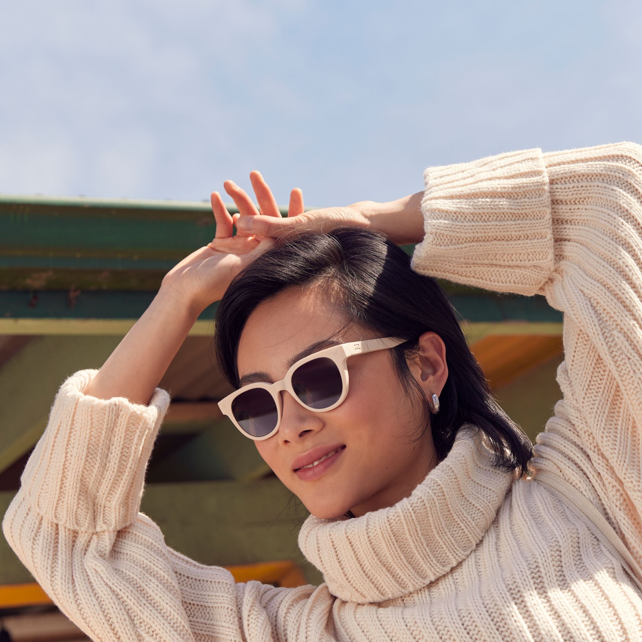 Unisex Rhodes Traveler Collection Sunglasses in Oatmilk colorway on model image
