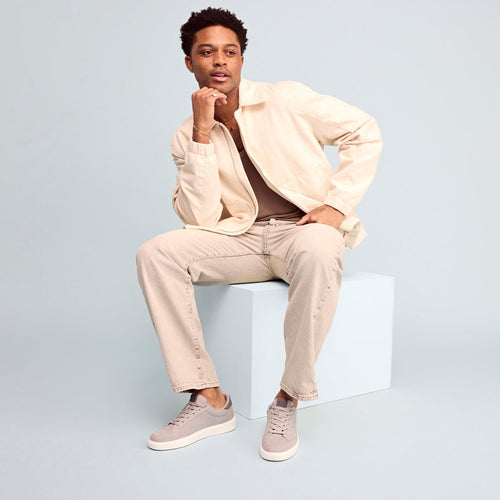 trvl lite rio lace up sneaker in grey textile on model in casual jeans and jacket