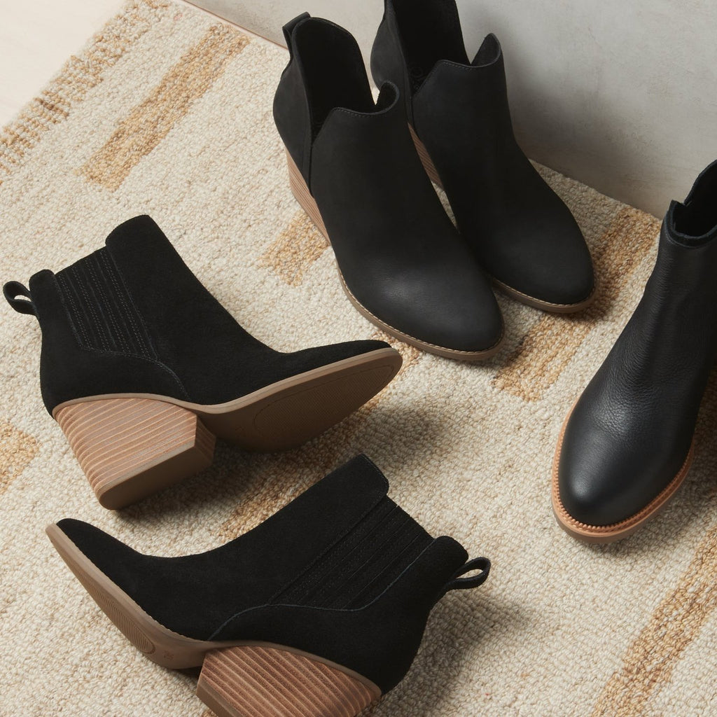 Laydown image of the black suede Noa block heeled boot