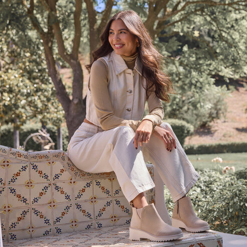 On figure image of the oatmeal suede Maude wedge bootie