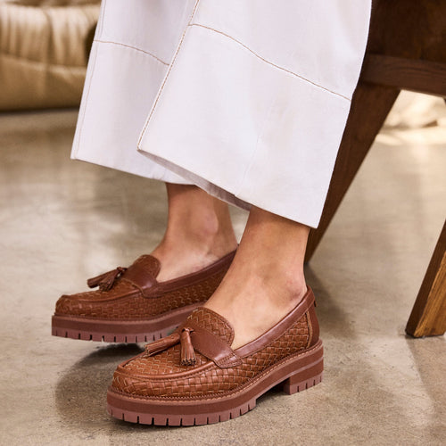 Up close on figure image of the amber brown faux leather tassel Cara loafer