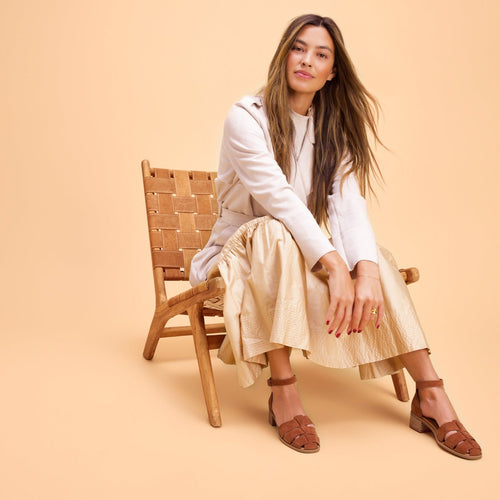 On figure lifestyle image of the Amber Brown Kid Suede Jaclyn Fisherman sandals