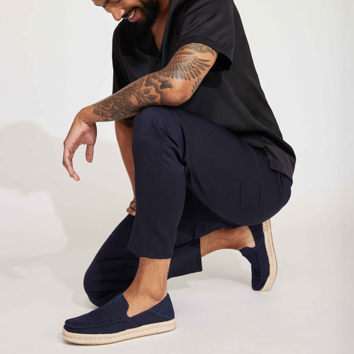 Alonso Rope Sole Moc Toe Loafer Slip On With Collapsible Heel On Model Squatting Against White Background