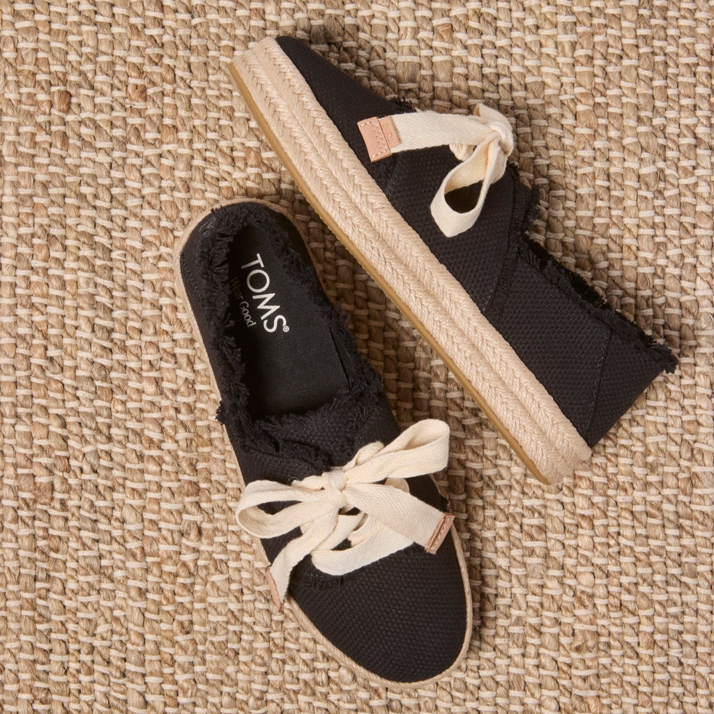 Laydown image of the black beachside woven lace up Carolina Espadrille