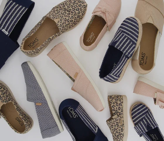 Various TOMS footwear shown.