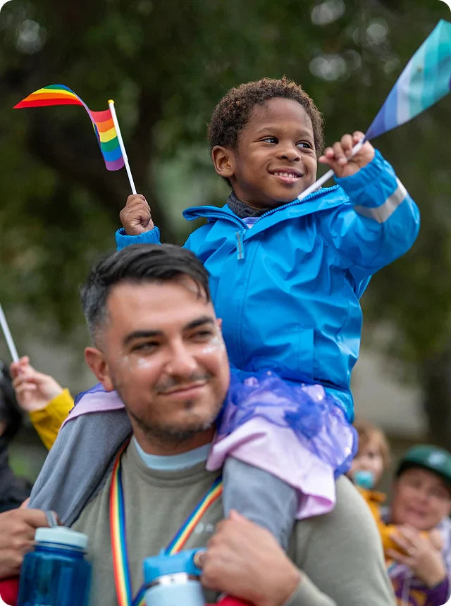 Someone from Brave Trails carrying a child on shoulders.