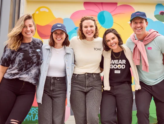 A group of TOMS employees shown.