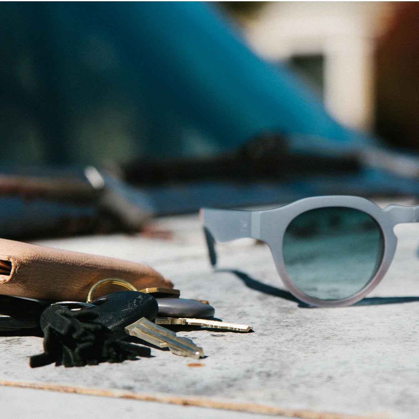 Wallet, car keys, and sunglasses shown.