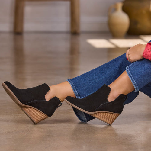 On model shot of the black suede Gwen wedge bootie