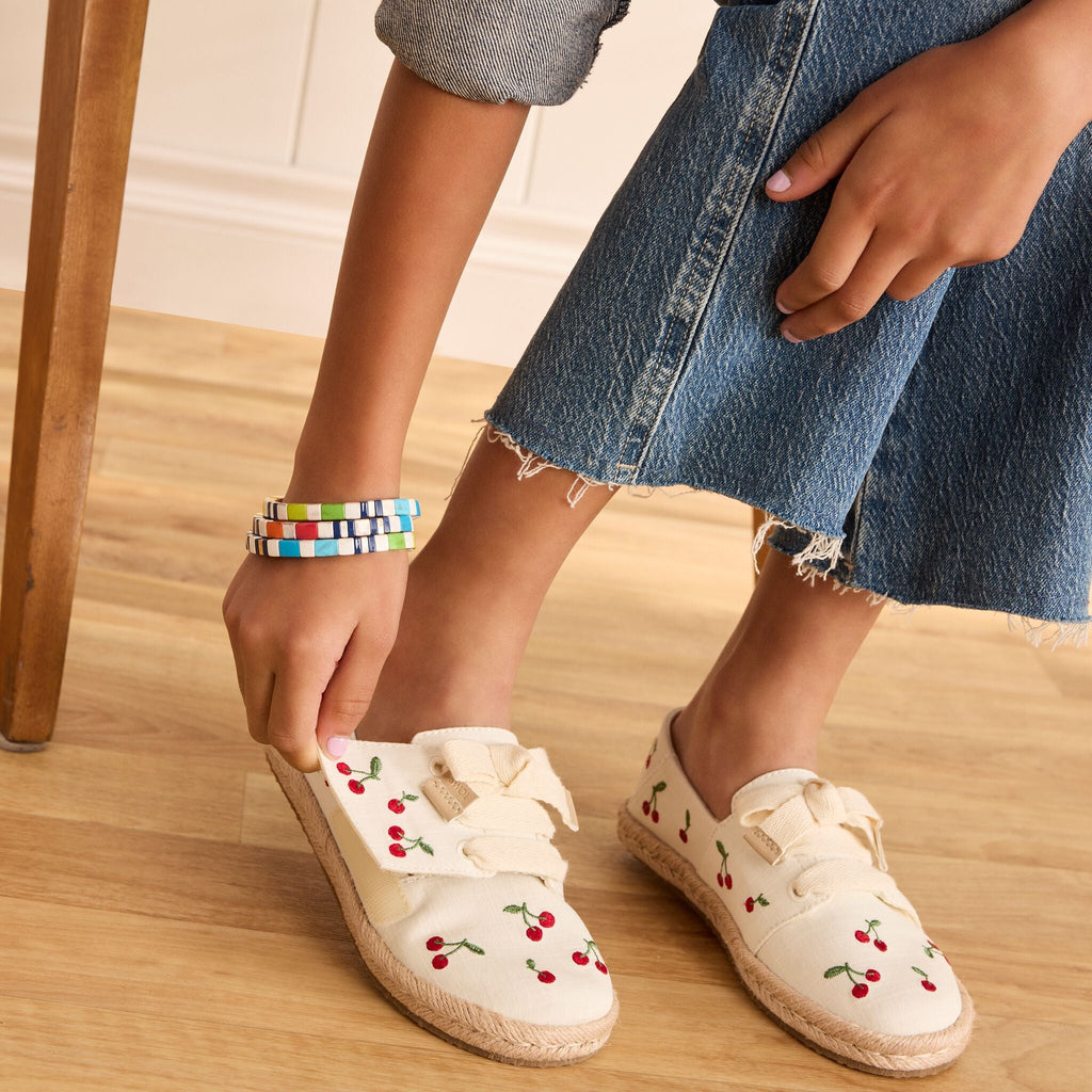 On model detail image of the Kids cherry Carolina lace up espadrilles