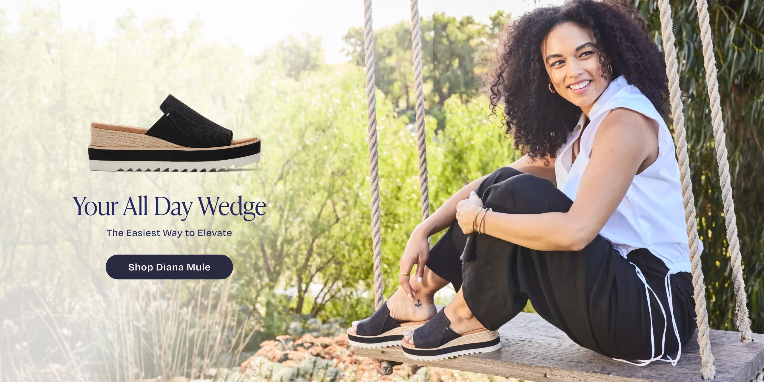 Your All Day Wedge. The Easiest Way to Elevate. Shop Diana Mule: model in Black Heavy Canvas, sitting on swing. Park background.