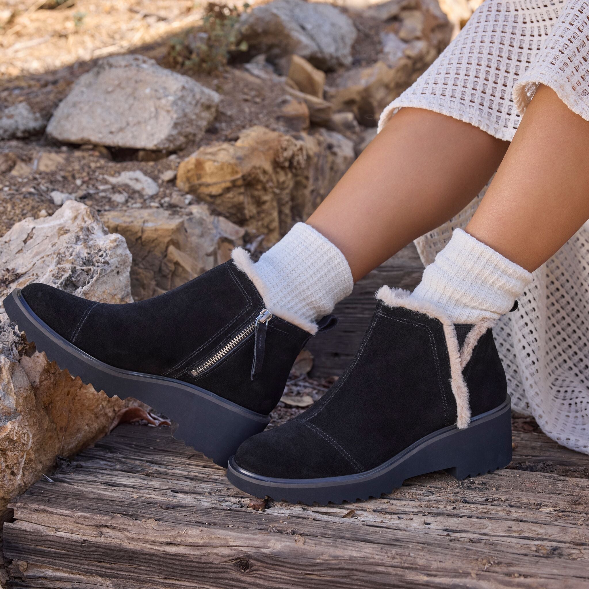 On figure image of the black suede Maude wedge boot with faux fur