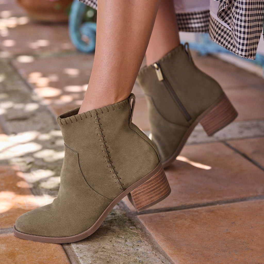 On figure image of olive green Delilah heeled boot