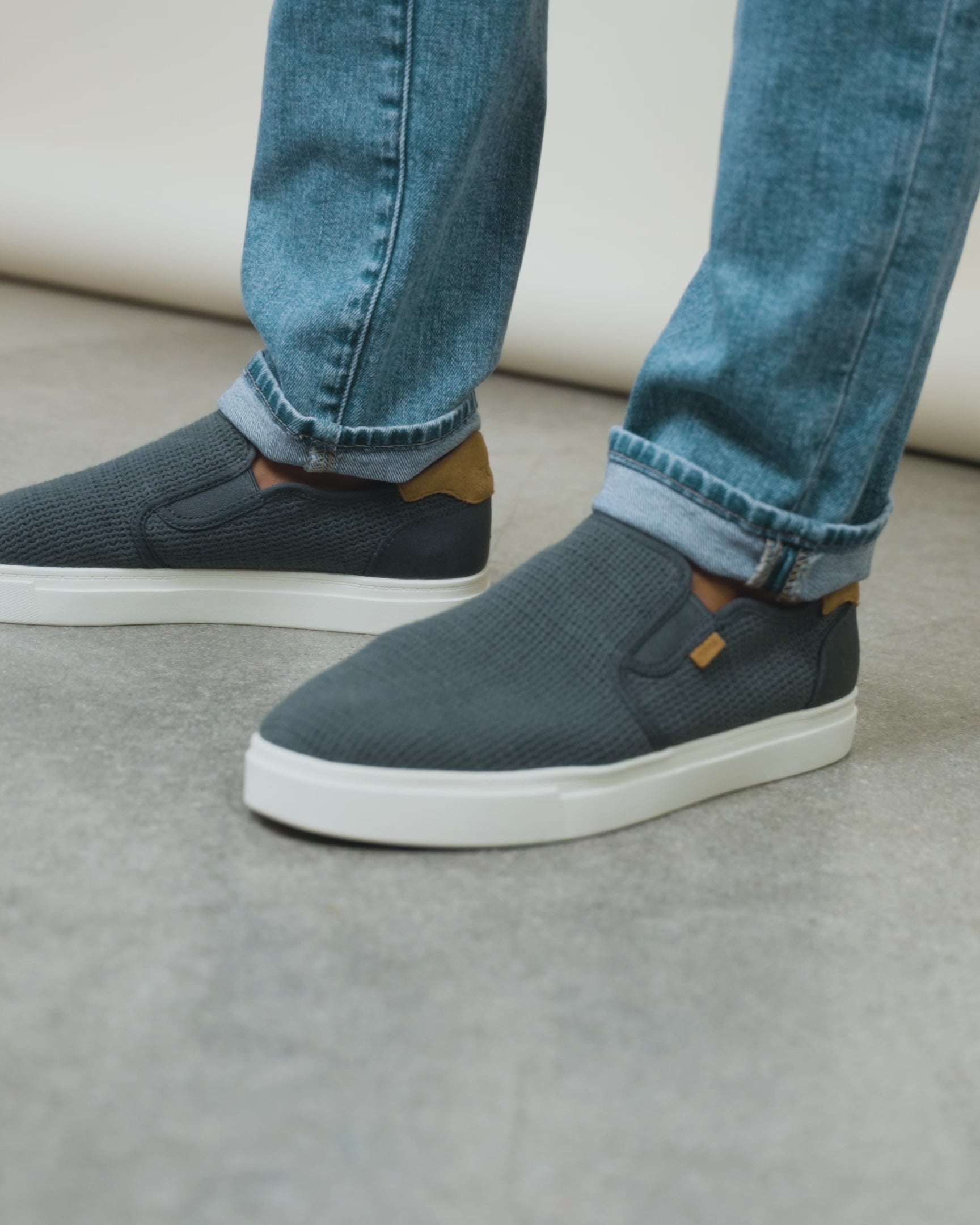 mens baja slip on sneaker on model styled with jeans.