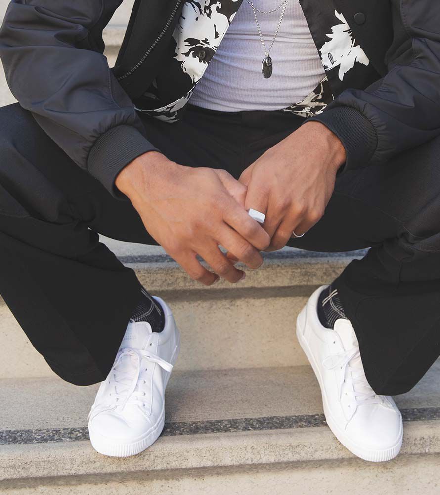Model wearing the Men's Carlo Sneaker in white.