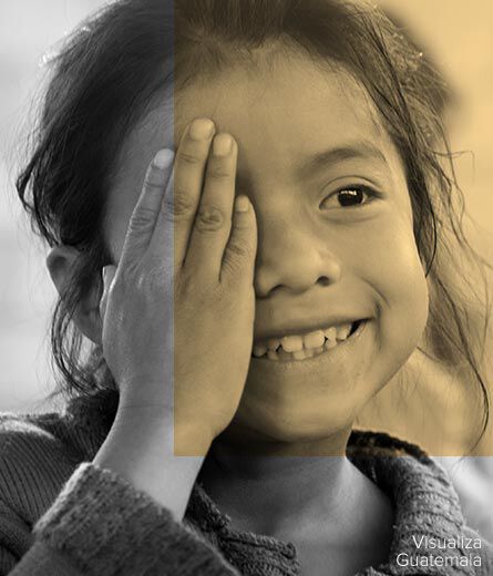 Featured: A young girl smiles and covers one eye with her handas she gets an eye exam