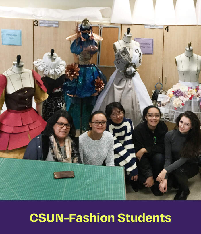 CSUN-Fashion Students. A group of women standing in front of mannequins wearing outfits.