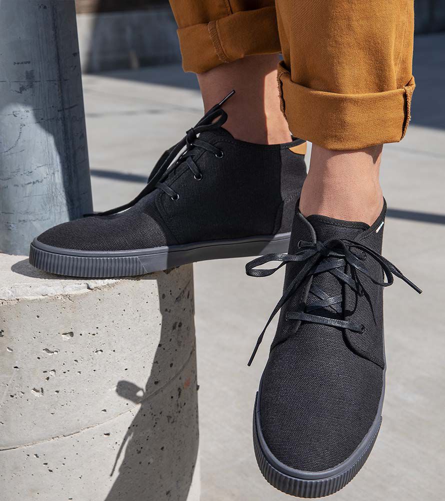 Cropped view feet of model wearing the Men's Carlo Sneaker in black.