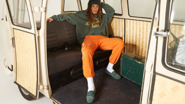 TOMS x KROST Collaboration. Model wearing the women's green suede TOMS X KROST Alpargata Espadrille Slip On shoe shown.