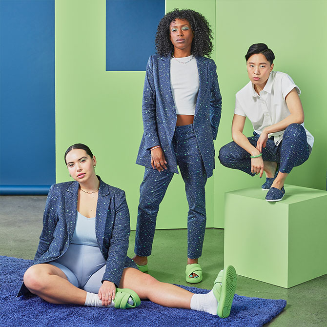 Models wearing the TOMS X Wildfang Mallow Crossover in arcadian green, the TOMS X Wildfang Alpargata in navy twill, the TOMS x WILDFANG Navy Orbits Print Stretch Cotton Twill Blazer and Blazer shown.