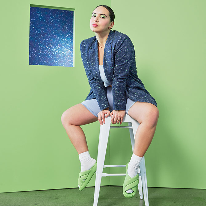 Model wearing the TOMS X Wildfang Mallow Crossover in arcadian green and the TOMS x WILDFANG Navy Orbits Print Stretch Cotton Twill Blazer shown.